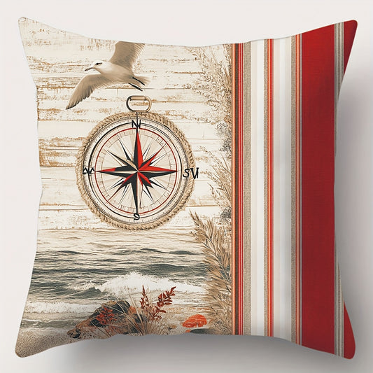 Square nautical pillow cover featuring a red, navy, and ivory compass design with coastal shoreline imagery and vertical stripe panel, hidden zipper closure.
