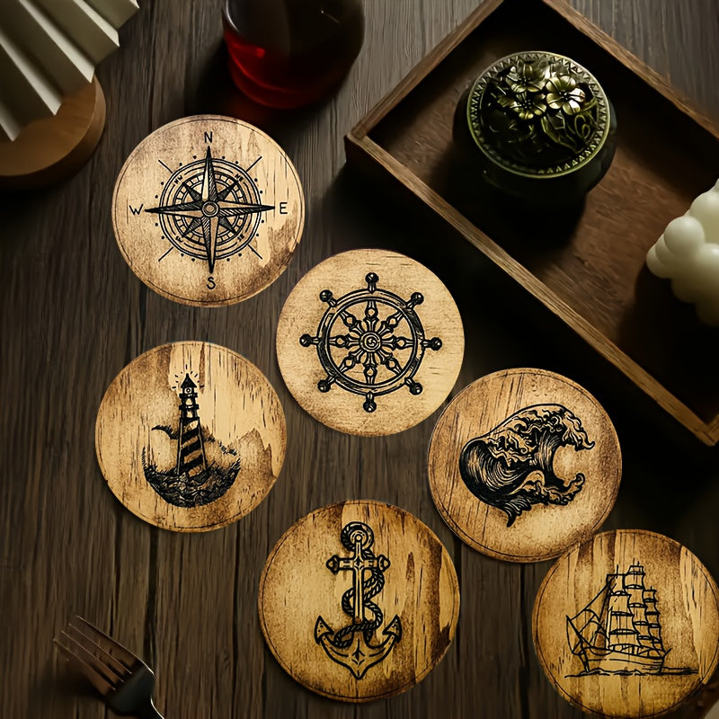 Round wooden coasters with engraved nautical designs including compass, anchor, ship, lighthouse, and wave on a wood table.
