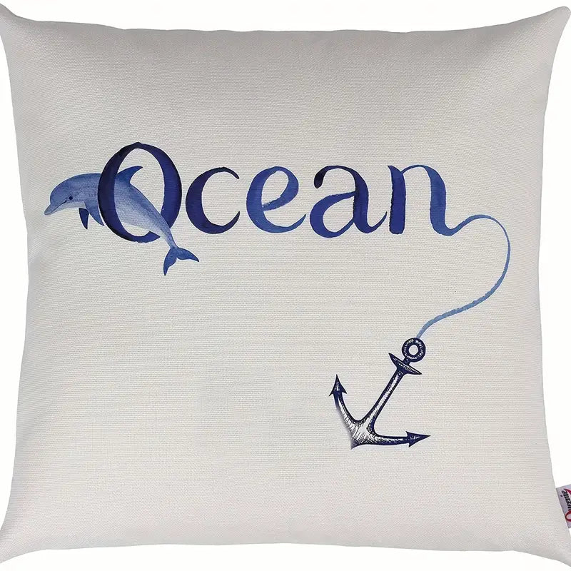 18"x18" linen pillow cover featuring the word “Ocean” with a dolphin and anchor graphic in blue on a cream background.