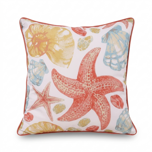 Warm coastal pillow cover with shells and starfish pattern in coral, blue, and yellow tones for beach house and coastal home decor.