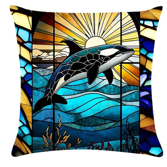 Square pillow cover featuring a centered orca above layered ocean waves with a radiant sun and stained-glass-style framing in blue and gold tones.
