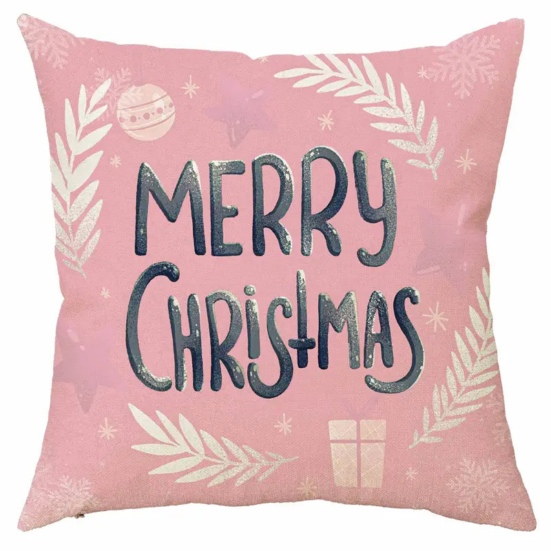 Pink Merry Christmas pillow cover with holiday pattern including ornaments, greenery, snowflakes, and gift box