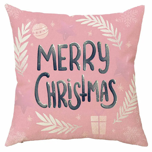 Pink Merry Christmas pillow cover with holiday pattern including ornaments, greenery, snowflakes, and gift box