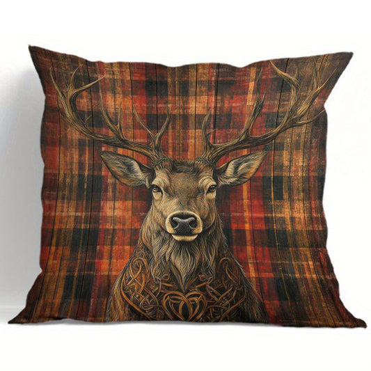 Deer pillow cover with centered stag illustration and minimal knot detailing on a red and green plaid background.