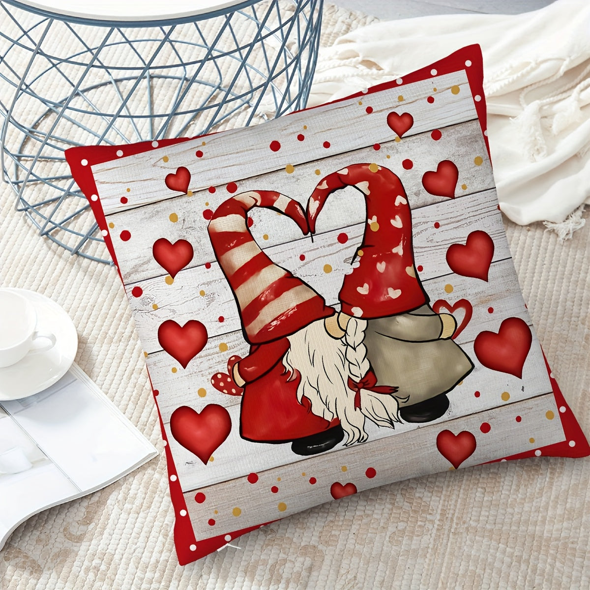 Playful 18x18 inch Valentine’s Day pillow cover with gnome couple forming a heart with their hats, red hearts and polka dots on white wood-grain background, styled on a sofa for seasonal décor – Coastal Pillows Plus.
