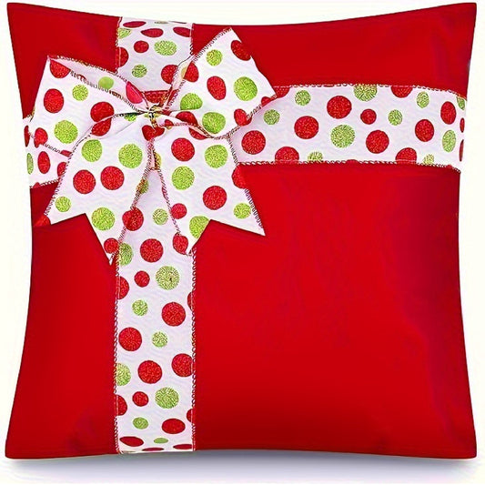 Red pillow cover with a ribbon bow and red and green dot pattern accents