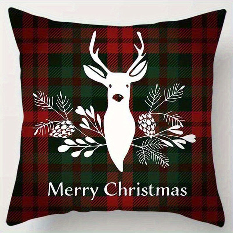 Red and green plaid pillow cover with a reindeer and greenery design