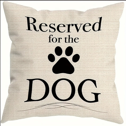 Decorative pillow with 'Reserved for the Dog' text and paw print on a beige background