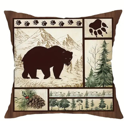 Square pillow cover featuring a bear silhouette facing right within a woodland collage of pine trees, mountains, and paw print accents.