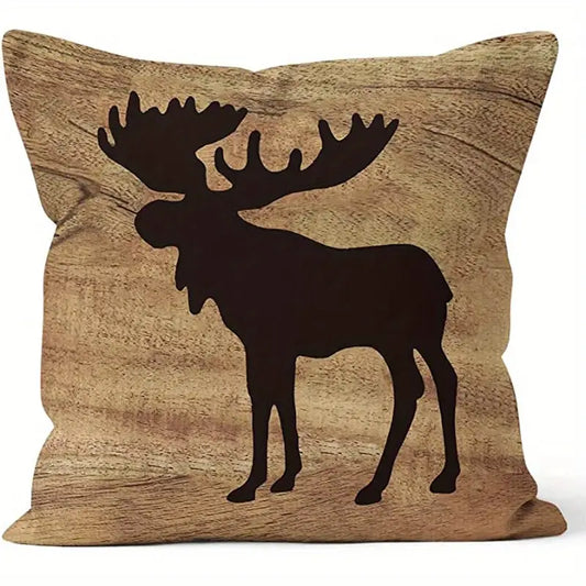 Square pillow cover featuring a dark moose silhouette against a warm wood-grain background.