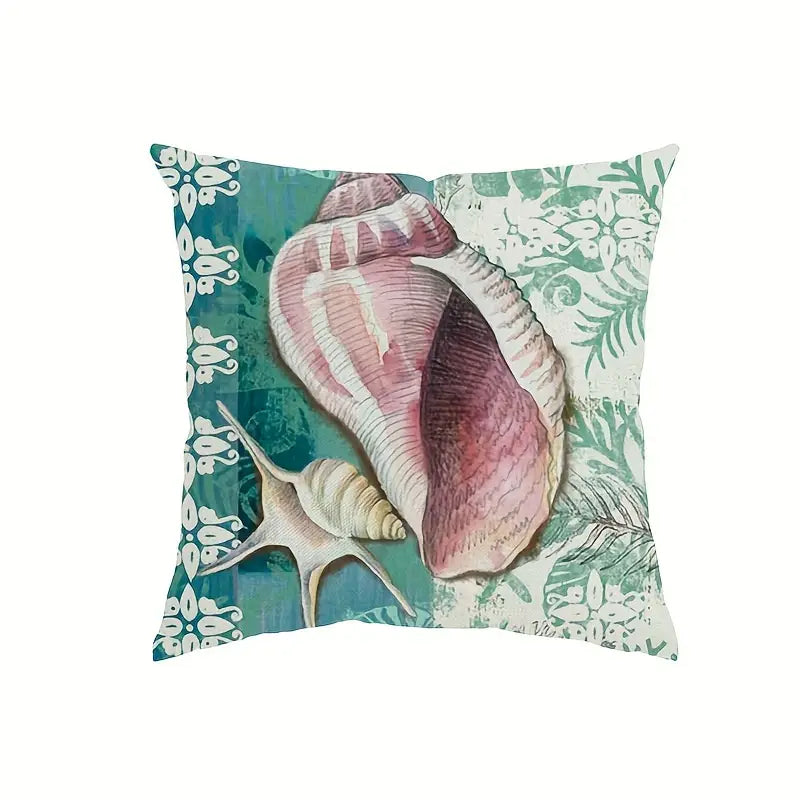 Square pillow cover featuring a large conch-style seashell and smaller shell against teal and cream patterned panels with decorative borders.