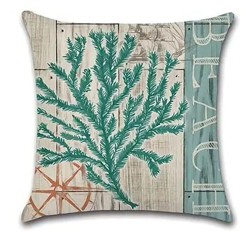 Pillow cover featuring a fine branching teal coral design on a weathered wood-style coastal background.