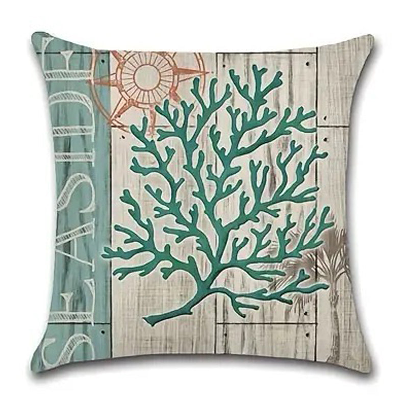 Pillow cover featuring an upright branching teal coral design on a weathered wood-style coastal background.