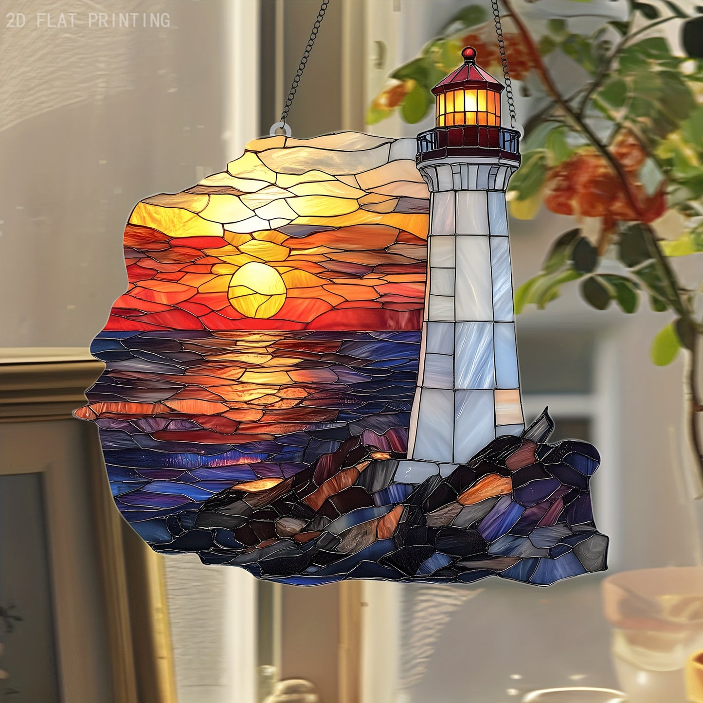Acrylic stained glass style lighthouse suncatcher with ocean sunset colors hanging in a window.