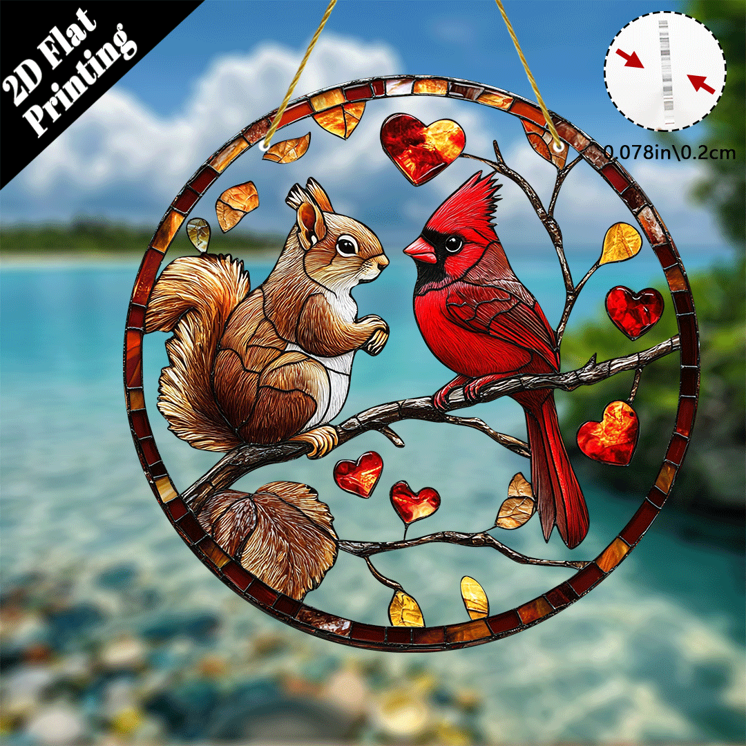 Acrylic stained glass style suncatcher with a squirrel and red cardinal on branches with heart shaped leaves.