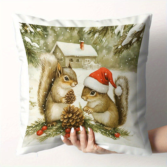Pillow cover with two squirrels holding a pinecone in a snowy winter scene