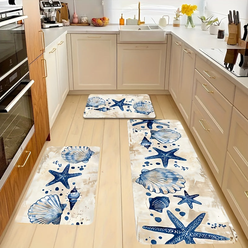 Coastal kitchen mat or runner featuring blue starfish and seashell patterns on a soft off-white background.