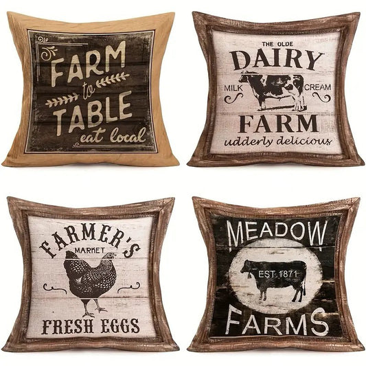 Four linen pillow covers featuring vintage farmhouse sign designs including Farm to Table, Olde Dairy Farm, Farmer’s Market Fresh Eggs, and Meadow Farms graphics.