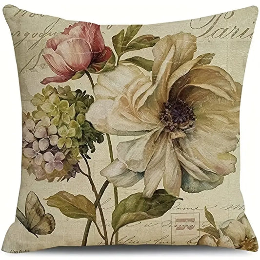 Decorative 18x18 linen pillow cover featuring a vintage-style poppy and hydrangea arrangement with greenery and butterfly accent on a neutral script background.