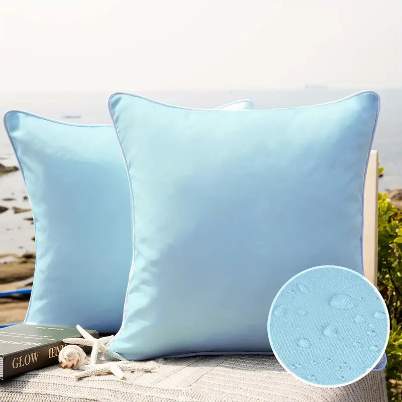 Solid light blue waterproof outdoor pillow cover displayed on patio seating with water-resistant fabric detail inset.