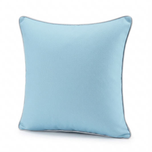 Solid light blue waterproof outdoor pillow cover displayed on patio seating with water-resistant fabric detail inset.