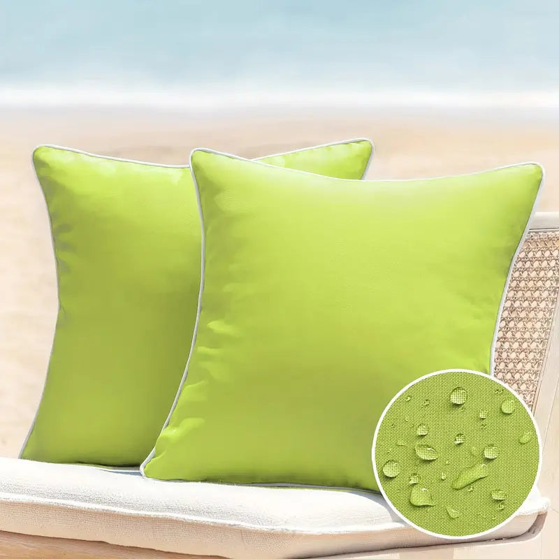 Solid lime green waterproof outdoor pillow cover displayed on a patio chair with a light cushion, shown with water-resistant fabric detail inset.