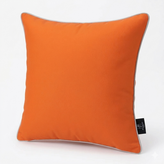 Solid orange waterproof outdoor pillow cover displayed on a patio chair with a light cushion, suitable for outdoor seating and porch décor.