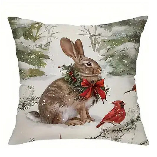 Winter pillow cover featuring a bunny in a snowy woodland scene with winter greenery and red berries.