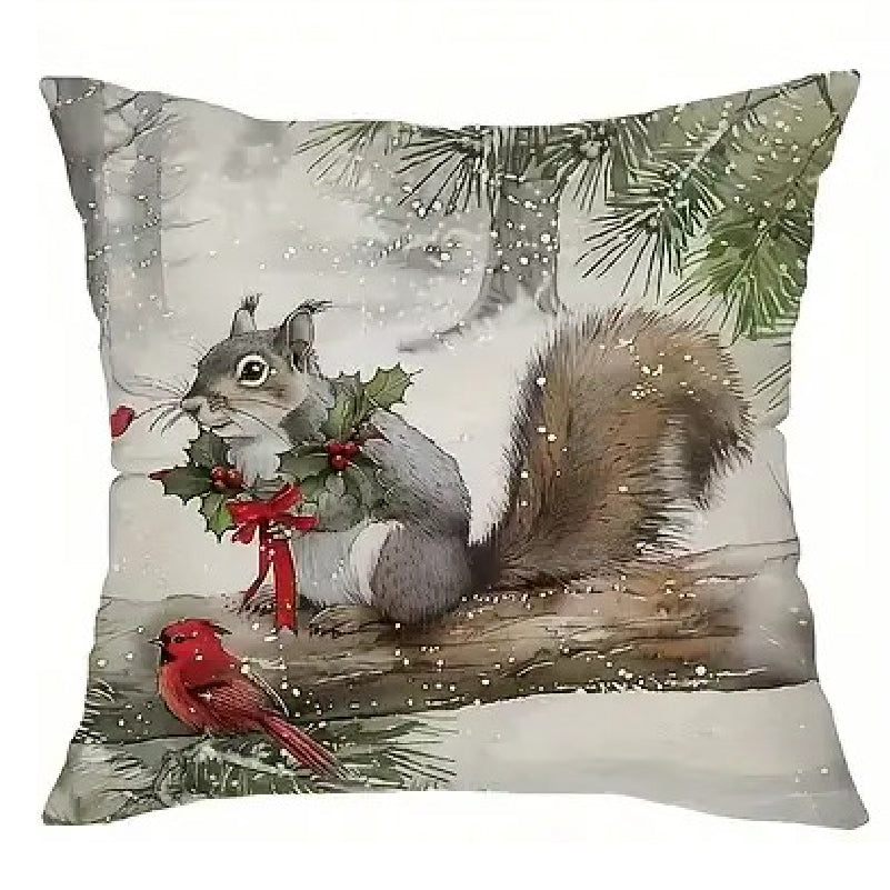 Winter pillow cover featuring a squirrel on a tree branch in a snowy forest with winter greenery.
