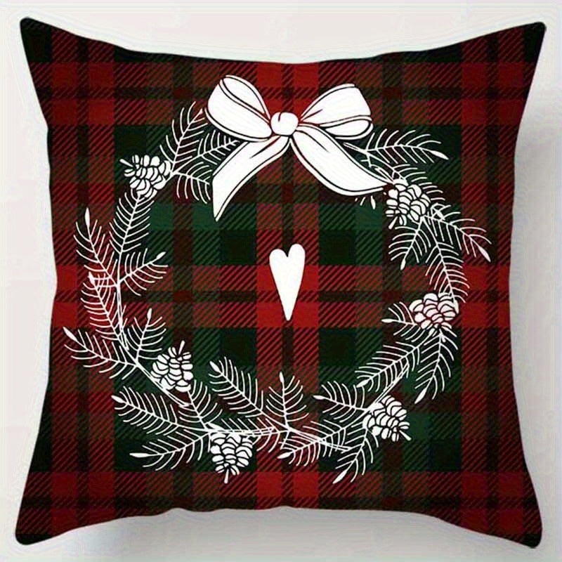 Red and green plaid pillow cover with a wreath and bow