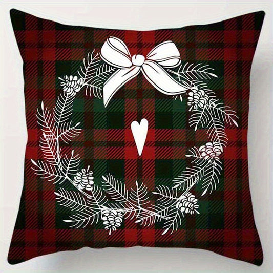 Red and green plaid pillow cover with a wreath and bow