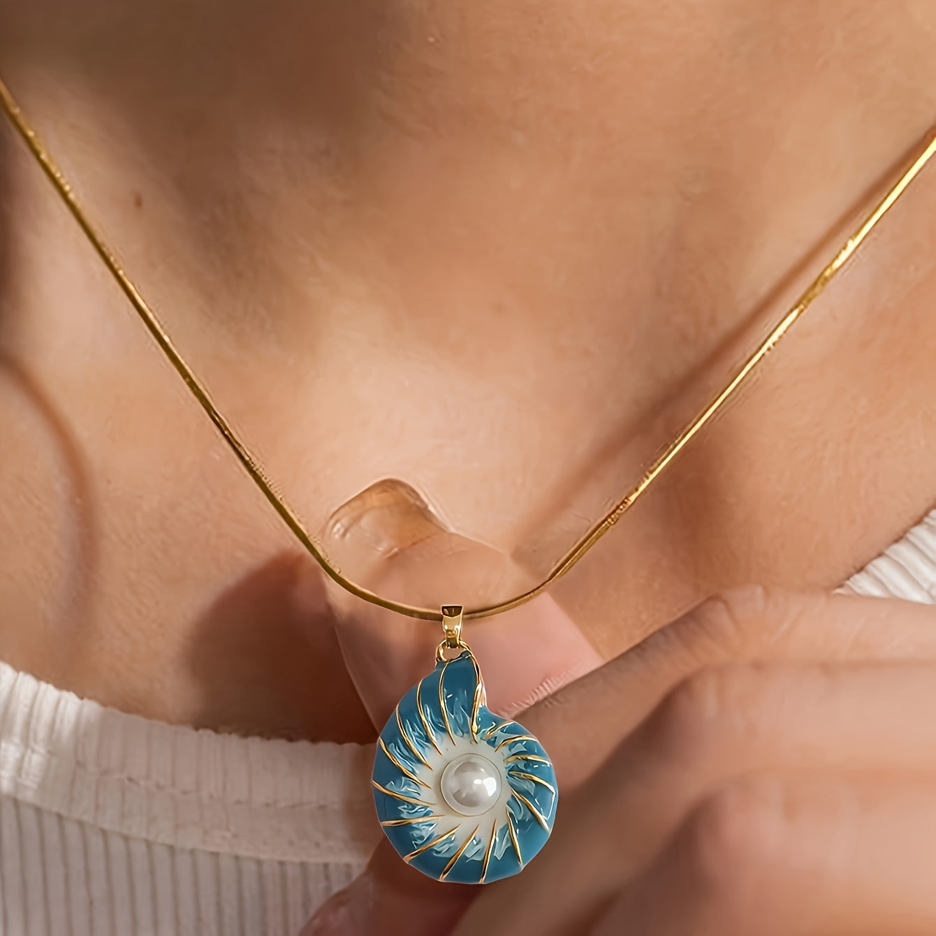 Vintage blue snail pendant necklace featuring a cultured-style pearl for a classic and unique nautical décor look.